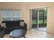 Cozy living room featuring comfortable seating, a ceiling fan, and sliding glass doors to the outdoors at 11236 Rouse Run Cir, Orlando, FL 32817