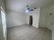 Bright living room featuring tile flooring, a ceiling fan, and neutral walls creating a welcoming space at 11236 Rouse Run Cir, Orlando, FL 32817