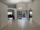 Bright, spacious living area with tile flooring, leading to a screened-in patio and other rooms at 11236 Rouse Run Cir, Orlando, FL 32817