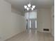 Bright living room featuring tile flooring and a decorative chandelier at 11236 Rouse Run Cir, Orlando, FL 32817