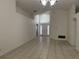 Bright living room with ceramic tile floors and lots of natural light shining through the front door at 11236 Rouse Run Cir, Orlando, FL 32817