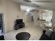 Open-concept living space with tile flooring, seamlessly connected to the dining area and a cozy sitting room at 11236 Rouse Run Cir, Orlando, FL 32817