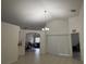 Bright, spacious living area with tile flooring, white walls, and a view into other rooms of the home at 11236 Rouse Run Cir, Orlando, FL 32817