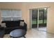 Cozy living room featuring a comfortable sofa and sliding glass doors to a screened-in porch, natural light at 11236 Rouse Run Cir, Orlando, FL 32817
