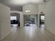 Spacious living room with ceramic tile floors, seamless access to a patio, and great room at 11236 Rouse Run Cir, Orlando, FL 32817