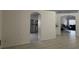 Open-concept living room with arched doorways leading to kitchen and additional living space at 11236 Rouse Run Cir, Orlando, FL 32817