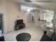 Open-concept living room with ceramic tile floors, comfortable seating, and adjacent dining area at 11236 Rouse Run Cir, Orlando, FL 32817