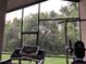 Screened porch area with a treadmill and workout machine, ideal for exercising at 11236 Rouse Run Cir, Orlando, FL 32817
