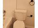 Clean bathroom showcasing a standard toilet, tile walls and black towel rack at 11588 Westwood Blvd # 1523, Orlando, FL 32821