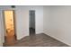 Bedroom view featuring modern wood-look floors, closet, and a glimpse into the bathroom at 11588 Westwood Blvd # 1523, Orlando, FL 32821
