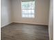 Bright bedroom featuring wood-look flooring and a window letting in natural light at 11588 Westwood Blvd # 1523, Orlando, FL 32821