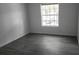 View of an empty room with wood floors and a window letting in natural light at 11588 Westwood Blvd # 1523, Orlando, FL 32821