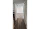 Hallway featuring modern wood-look floors, leading to the main living area at 11588 Westwood Blvd # 1523, Orlando, FL 32821