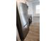 Modern kitchen with stainless steel refrigerator and wood-look flooring at 11588 Westwood Blvd # 1523, Orlando, FL 32821