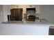 Open kitchen view showcasing granite counters, stainless appliances, and seamlessly connecting to the living area at 11588 Westwood Blvd # 1523, Orlando, FL 32821