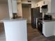 Open kitchen view showcasing granite counters, stainless appliances, and seamlessly connecting to the living area at 11588 Westwood Blvd # 1523, Orlando, FL 32821
