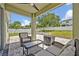 Outdoor patio featuring wicker furniture, a ceiling fan, and backyard views at 11616 Thacker Dr, Clermont, FL 34711
