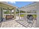 Outdoor patio with pergola, grill, and seating area for relaxing and entertaining at 11616 Thacker Dr, Clermont, FL 34711