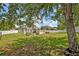 Lush backyard featuring a manicured lawn, a patio, and privacy fencing at 11616 Thacker Dr, Clermont, FL 34711