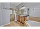 Well-lit bathroom showcasing a glass shower, soaking tub, and ample counter space at 11616 Thacker Dr, Clermont, FL 34711