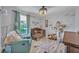 Charming Bedroom with a wooden crib, comfortable chair, and whimsical decor at 11616 Thacker Dr, Clermont, FL 34711