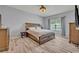 Spacious bedroom with wood-look floors, a large bed, and natural light from the window at 11616 Thacker Dr, Clermont, FL 34711
