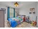 Bright bedroom featuring playful decor, hardwood floors, and a ceiling fan at 11616 Thacker Dr, Clermont, FL 34711