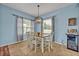 Dining room with a modern light fixture and bright light from the windows at 11616 Thacker Dr, Clermont, FL 34711