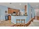 Well-equipped kitchen with breakfast bar, wooden cabinets, and stainless-steel appliances in an open layout at 11616 Thacker Dr, Clermont, FL 34711