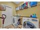 Well-organized laundry room with modern washer/dryer and ample storage space at 11616 Thacker Dr, Clermont, FL 34711
