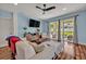 Cozy living space with sliding glass doors to the backyard, hardwood floors, and contemporary furnishings at 11616 Thacker Dr, Clermont, FL 34711
