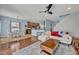 Open-concept living area with a dining space, sleek ceiling fan, and hardwood floors, great for entertaining at 11616 Thacker Dr, Clermont, FL 34711