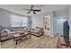 Comfortable living room features a sofa, coffee table with games, and wood-look flooring at 11616 Thacker Dr, Clermont, FL 34711