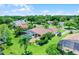 Aerial view of the home, screened pool, outdoor kitchen, lush landscaping, and lake views at 13626 Sunset Lakes Cir, Winter Garden, FL 34787