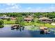 Aerial view of the neighborhood, lakefront homes, boat docks, and lush greenery in a tranquil setting at 13626 Sunset Lakes Cir, Winter Garden, FL 34787