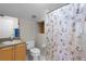 Cozy bathroom featuring a shower with a seashell curtain, sink with vanity and other amenities at 13626 Sunset Lakes Cir, Winter Garden, FL 34787