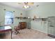 Bedroom showcasing light green walls, window, ceiling fan and an area with decorative objects and furniture at 13626 Sunset Lakes Cir, Winter Garden, FL 34787