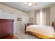 Cozy bedroom with a comfortable bed, neutral walls, soft curtains, and closet space, creating a relaxing atmosphere at 13626 Sunset Lakes Cir, Winter Garden, FL 34787