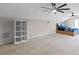 Spacious bedroom with vaulted ceilings, dual ceiling fans, a comfortable bed, and a built in bookshelf at 13626 Sunset Lakes Cir, Winter Garden, FL 34787