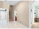 Spacious hallway featuring tiled floors, staircase, and multiple doorways, offering seamless transitions between rooms at 13626 Sunset Lakes Cir, Winter Garden, FL 34787