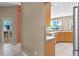 Bright kitchen with tile flooring, stainless steel refrigerator, wood cabinets, and a view to the backyard at 13626 Sunset Lakes Cir, Winter Garden, FL 34787