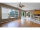 Bright living room with hardwood floors, neutral walls, and scenic views of the backyard at 13626 Sunset Lakes Cir, Winter Garden, FL 34787