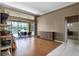 Open-concept living room with hardwood floors, access to the screened lanai, and lots of natural light at 13626 Sunset Lakes Cir, Winter Garden, FL 34787