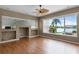 Bright living room with hardwood floors, neutral walls, and scenic lake views at 13626 Sunset Lakes Cir, Winter Garden, FL 34787