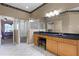 Bright ensuite bathroom with a step-in shower, tiled floors, and a vanity with a black countertop at 13626 Sunset Lakes Cir, Winter Garden, FL 34787