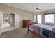 Large main bedroom featuring carpet floors, a ceiling fan, and a private entrance to the backyard at 13626 Sunset Lakes Cir, Winter Garden, FL 34787