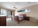 Spacious bedroom with a ceiling fan, carpet flooring, and natural light from multiple windows at 13626 Sunset Lakes Cir, Winter Garden, FL 34787