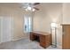 Bright office space with carpet floors, a ceiling fan, and a dark wood desk with ample storage at 13626 Sunset Lakes Cir, Winter Garden, FL 34787