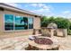 Outdoor kitchen with stone barbecue and fire pit, plus seating, creating an ideal space for entertaining at 13626 Sunset Lakes Cir, Winter Garden, FL 34787