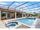 This beautiful screened pool features a spa, waterfall, and extensive outdoor living area at 13626 Sunset Lakes Cir, Winter Garden, FL 34787